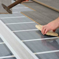 Varmt golv under laminatet på betonggolvet: designnyanser + detaljerad installationsinstruktion