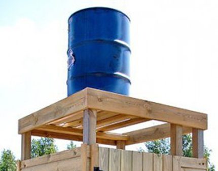 Barrel of a summer shower on a wooden support