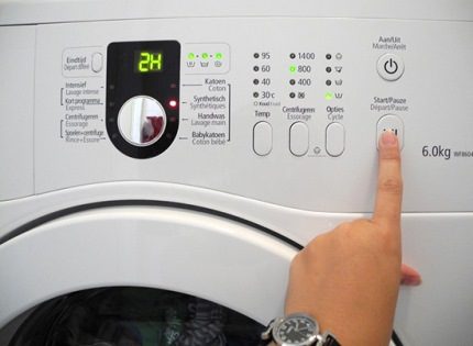 The button to start washing in the device