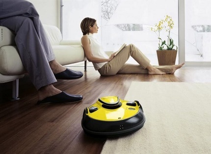 Robot vacuum cleaner Karcher cleans the floor in the apartment