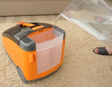 Pouring water into the vacuum cleaner compartment