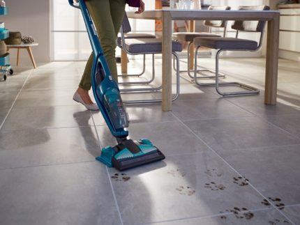 Cleaning the kitchen with a vacuum cleaner