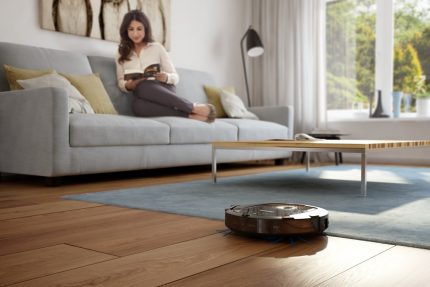 Robot vacuum cleaner in the process of cleaning the laminate