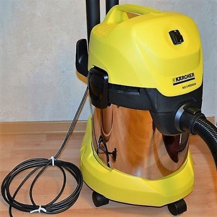 The vacuum cleaner is stored in the corner of the room.
