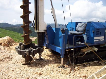 Auger well drilling