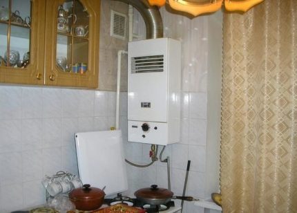 Wall-mounted gas boiler in the kitchen in the apartment