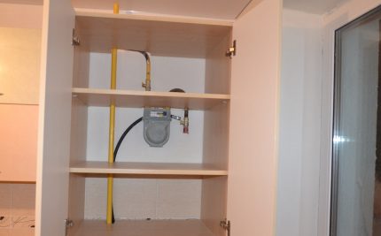 Gas meter behind the cabinet