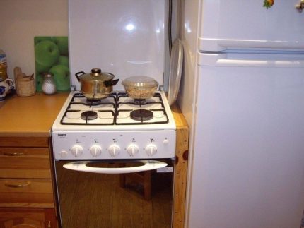 Gas stove next to the refrigerator