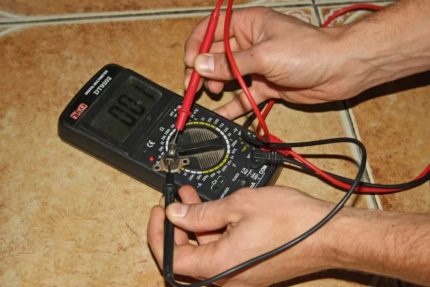 Checking the electrics of a gas boiler with a multimeter